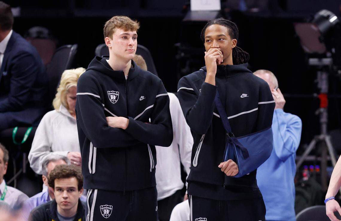 Duke’s Cooper Flagg and Maliq Brown watch the team warmup before Duke’s game against North Carolina in the semifinals of the 2025 ACC Men’s Basketball Tournament at the Spectrum Center in Charlotte, N.C., Friday, March 14, 2025.