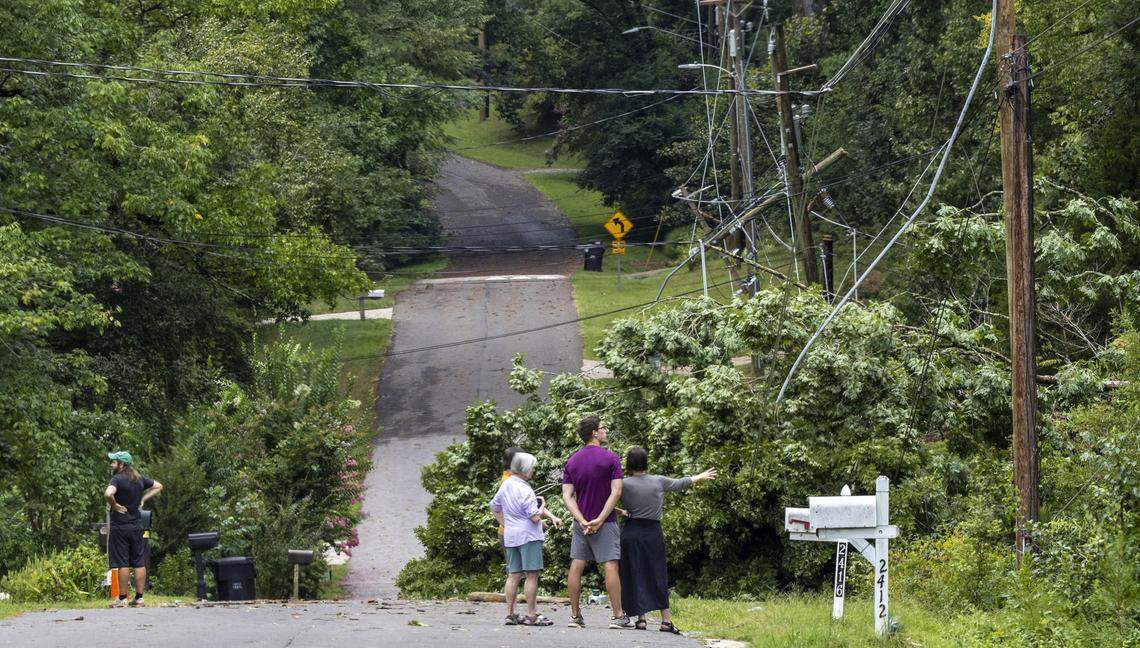 Neighbors check out storm damage on Alpine Road in Durham following a severe thunderstorm that swept through the Triangle on Tuesday afternoon, Aug 15, 2023.