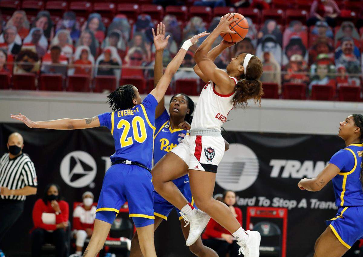 N.C. State’s Kai Crutchfield (3) shoots as Pittsburgh’s Jayla Everett (20) and Taisha Exanor (3) defend during the second half of N.C. State’s 83-53 victory over Pittsburgh at Reynolds Coliseum in Raleigh, N.C., Thursday, February 25, 2021.