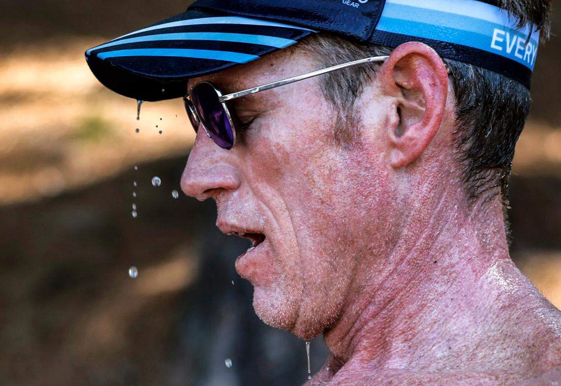 Van Fletcher, 49, of Raleigh, cools down as he takes a break from training at N.C. State’s Paul Derr Track and Field facility in Raleigh, N.C., at 10:30 Wednesday morning June 26, 2024. Fletcher was running 11 miles as part of his training for two upcoming Ironman competitions. Regarding running in the heat, Fletcher said, “In ideal world I get here at six (am). But I don’t work in an ideal world.” Fletcher took breaks and hydrated frequently.