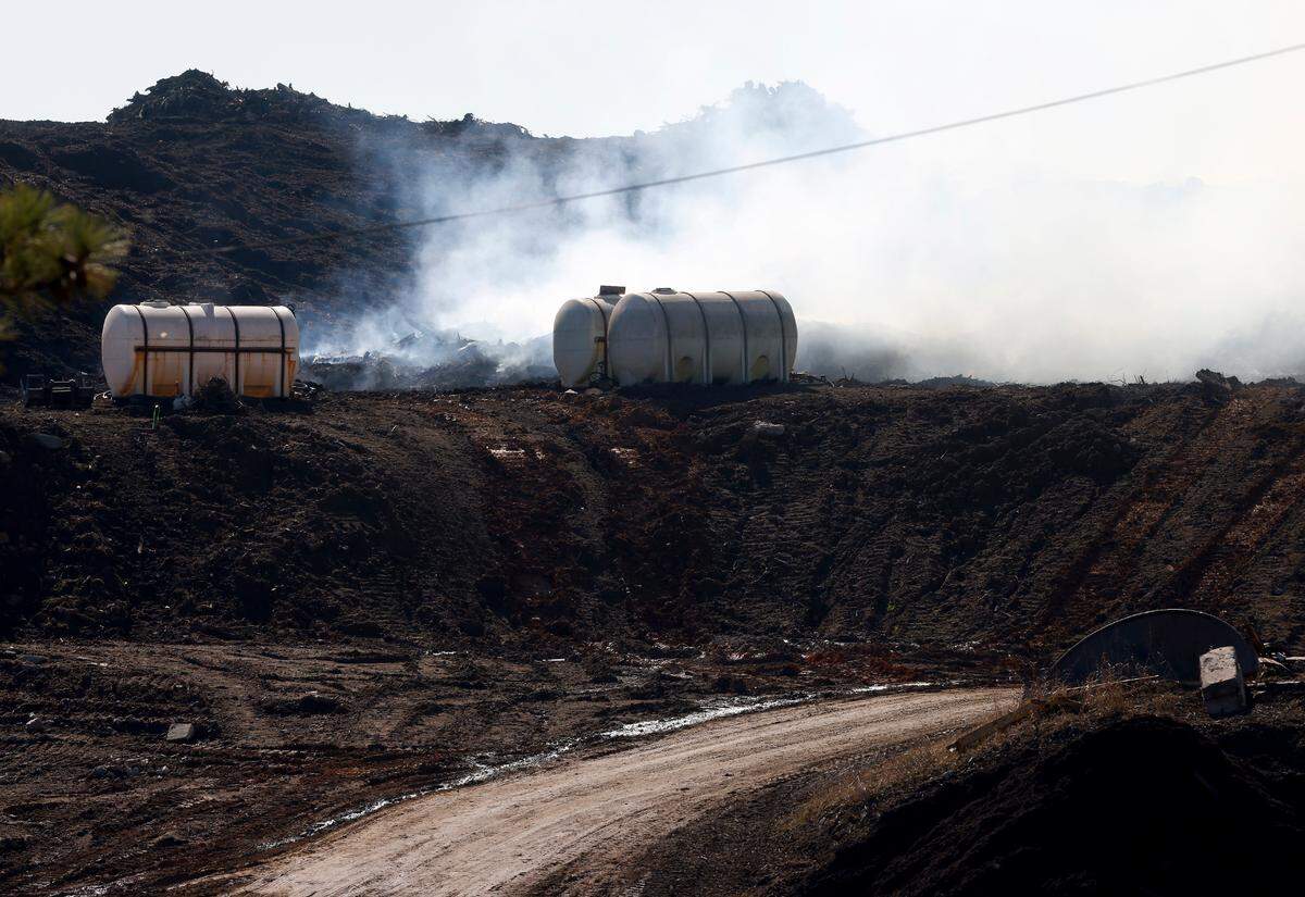 Smoke is seen in the air above Wall Recycling Raleigh on Tuesday, Nov. 29, 2022, in Raleigh, N.C.