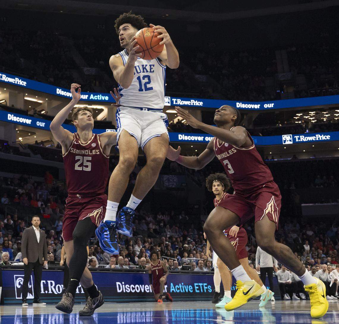 Duke forward Cameron Boozer (12) secures an offensive rebound between Florida State forwards Alex Steen (25) and Thomas Bassong (3) in the first half on Thursday, March 12, 2026, during the quarterfinals of the ACC Tournament at Spectrum Center in Charlotte, N.C.