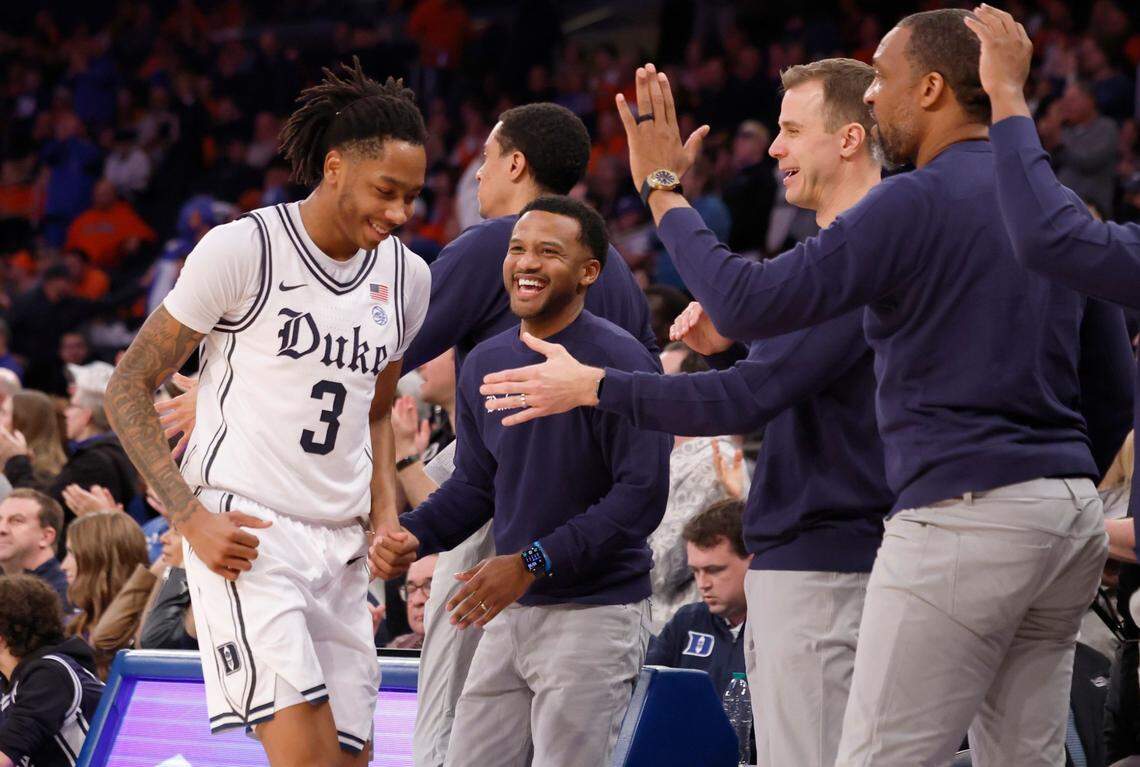 Duke associate head coach Jai Lucas, along with head coach Jon Scheyer, and associate head coach Chris Carrawell congratulate Isaiah Evans (3) as he comes off the floor in the second half of Duke’s 110-67 victory over Illinois in the SentinelOne Classic at Madison Square Garden in New York City Saturday, Feb. 22, 2025.