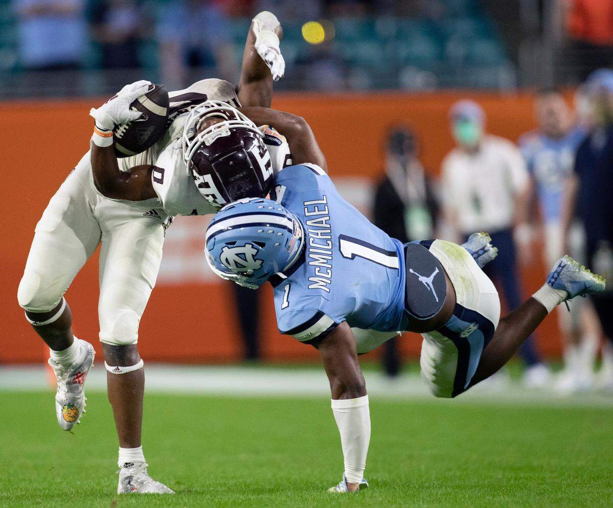 North Carolina’s Kyler McMichael (1) stops Texas A&M’s Ainias Smith (0) after a 14-yard pass completion in the third quarter during the Capital One Orange Bowl on Saturday, January 2, 2021in Miami Gardens, Florida.