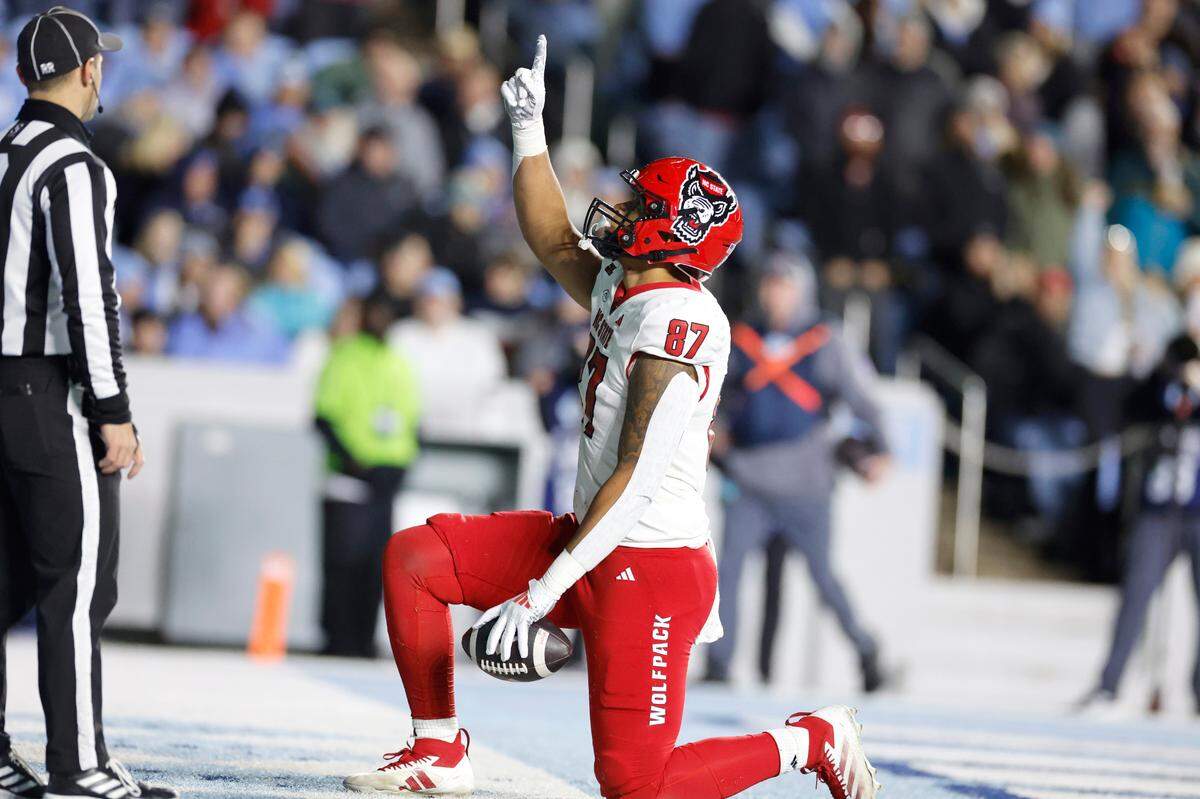 N.C. State tight end Dante Daniels (87) celebrates a 14-yard touchdown reception during the second half of N.C. State’s 35-30 victory over UNC at Kenan Stadium in Chapel Hill, N.C., Saturday, Nov. 30, 2024.