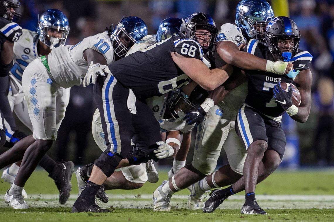 North Carolina’s Kevin Hester Jr. stops Duke’s Jordan Waters (7) for a one yard gain in the fourth quarter on Saturday, October 15, 2022 at Wallace-Wade Stadium in Durham, N.C.