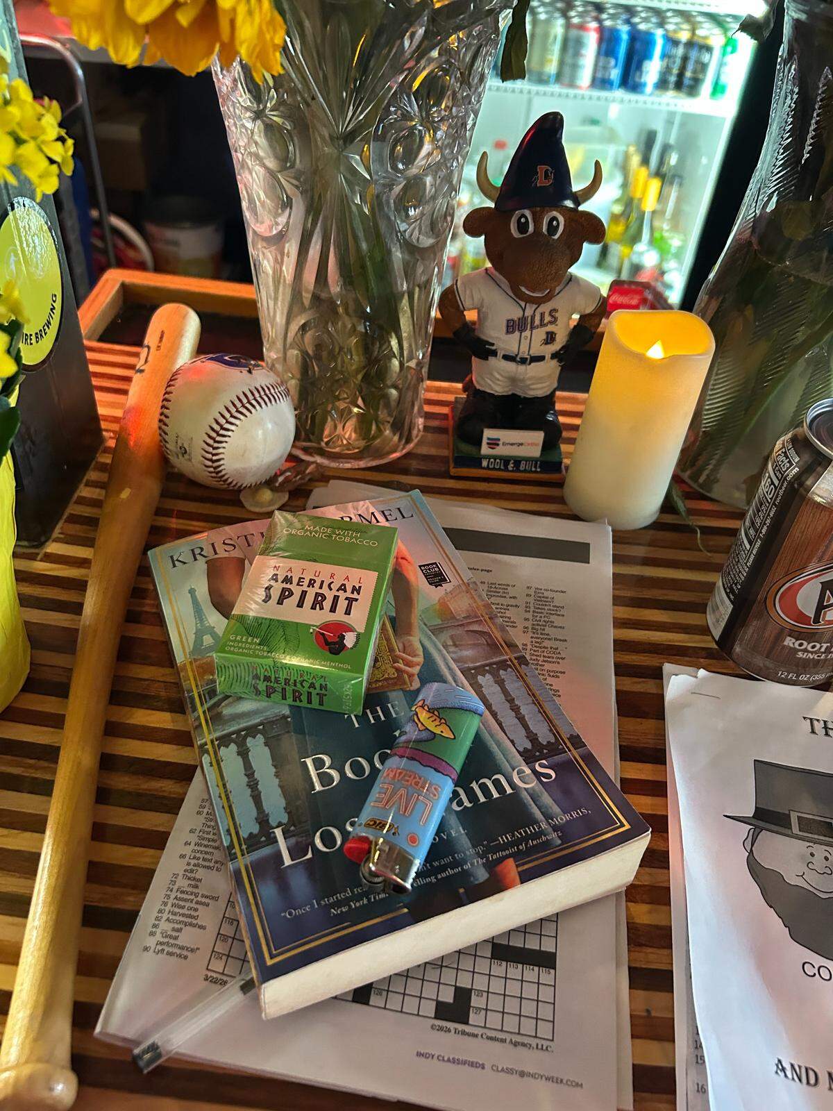 Tributes left in memory of Lisa Lewis at her corner of the bar at Berkeley Cafe, including crossword puzzles and her favored American Spirit cigarettes.