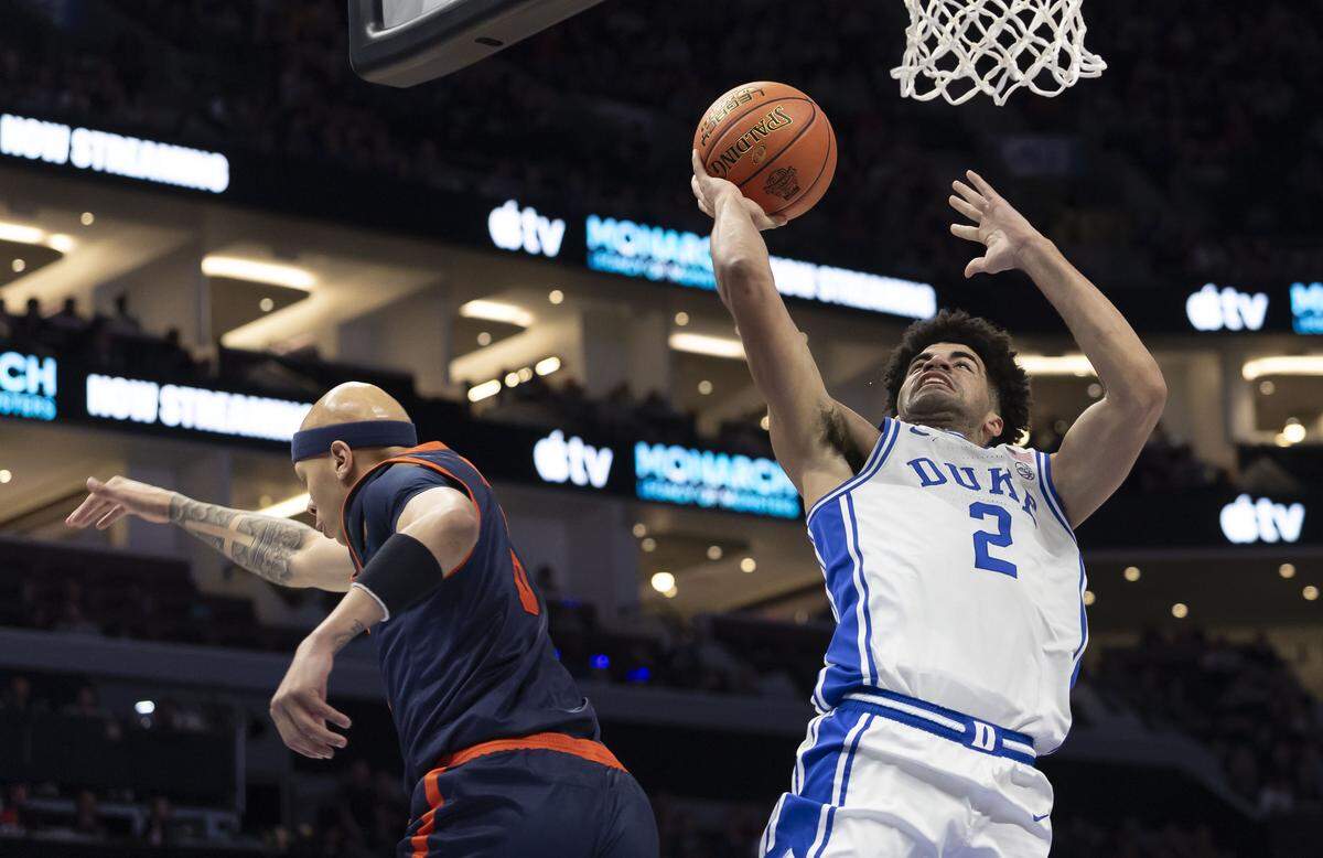 Duke guard Cayden Boozer (2) beats Virginia guard Jacari White (6) to the basket in the first half on Saturday, March 14, 2026, during the ACC Tournament Championship at Spectrum Center in Charlotte, N.C.  Boozer scored 14 points in the first half.