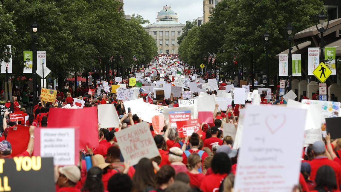 Marchers walk up Raleigh’s Fayetteville Street during the March for Students and Rally for Respect on May 16, 2018. (News and OBserver file photo.)