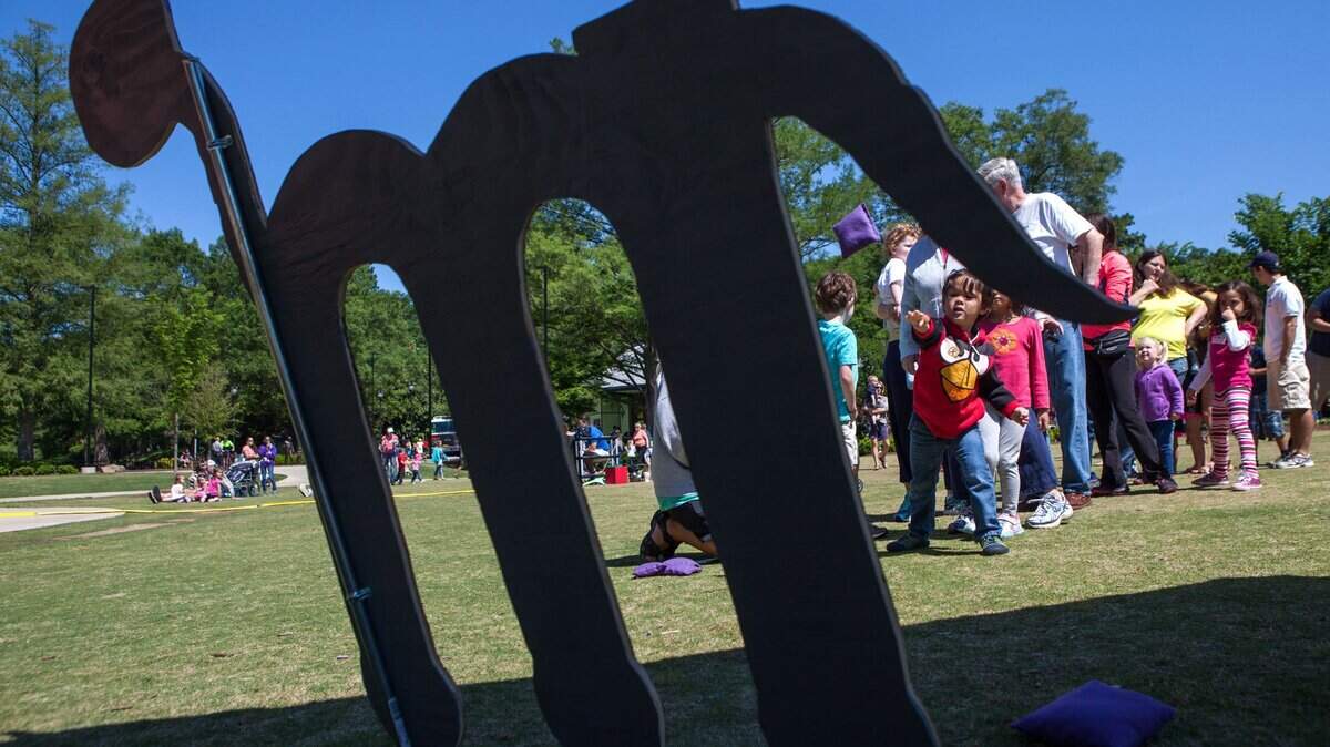 Seth Aldianto, 4, tosses a bean bag at a letter "M" for "Munching Mike" during Letterland Adventure Day at Pullen Park on May 17, 2014 in Raleigh. The Wake County Public School System, WAKE Up and Read, and Raleigh Parks and Recreation worked together to bring characters from the popular phonics program to life.