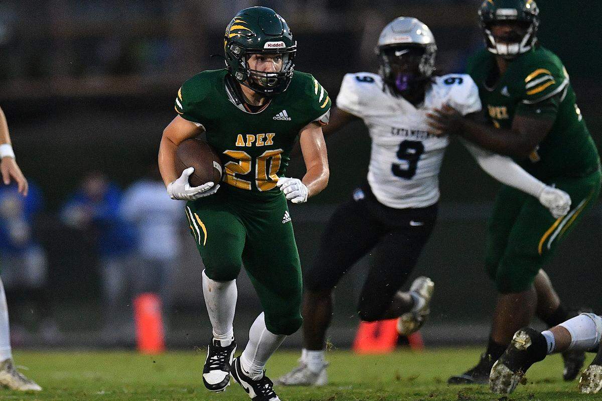 Apex running back Kaiden Dupree (20) runs for yardage against Panther Creek during the first half. The Apex Cougars and the Panther Creek Catamounts met in a conference football game in Apex, N.C. on September 20, 2024.