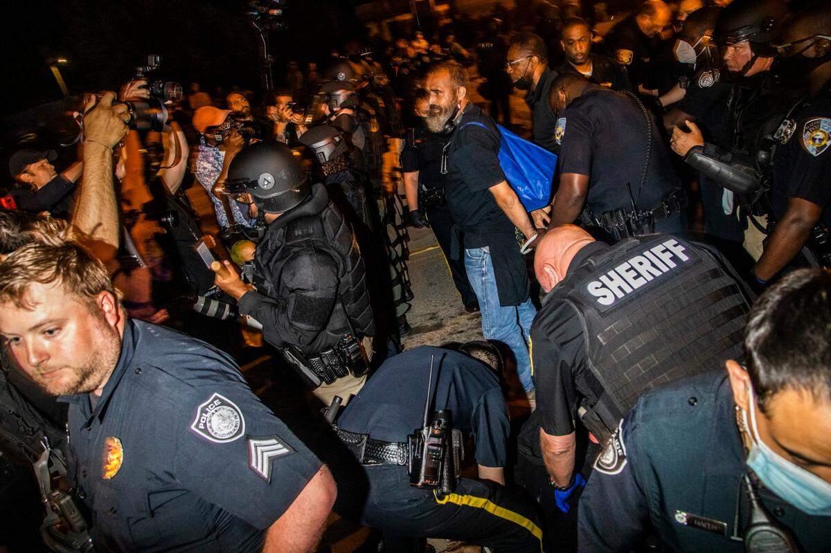 A demonstrator protesting the police killing of Andrew Brown Jr.are arrested Tuesday, April 27, 2021 in downtown Elizabeth City. At least six protesters were arrested when police in riot gear marched toward roughly a dozen protesters two hours past curfew. Protesters were peaceful but refused to clear the streets.