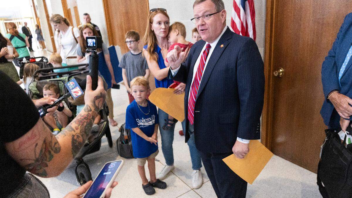House Speaker Tim Moore accepts a letter on Wednesday, July 31, 2024 signed by N.C. parents urging Republican lawmakers to keep their promise to fully fund private school vouchers for 55,000 students on a state waitlist. Critics of the voucher expansion say lawmakers should prioritize public schools.