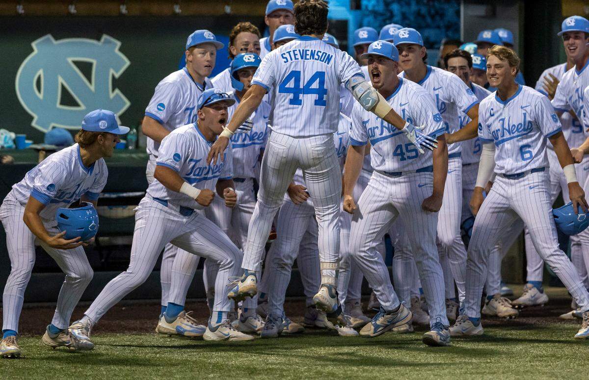 North Carolina catcher Luke Stevenson (44) is welcomed to the dugout by his teammate after a solo home run in the ninth inning to tie West Virginia 6-6 during the NCAA Super Regional on Friday, June 7, 2024 at Boshamer Stadium in Chapel Hill, N.C.