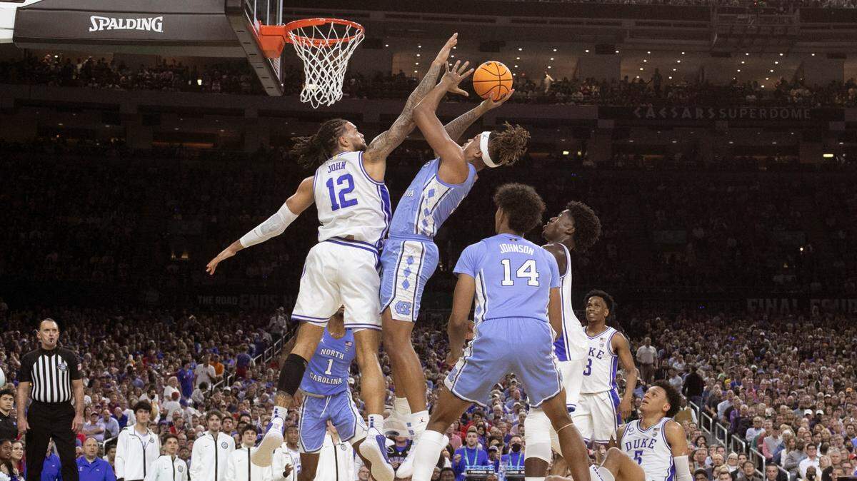 North Carolina’s Armando Bacot (5) shoots as Duke’s Theo John (12) defends during UNC’s 81-77 victory over Duke in the Final Four at Caesars Superdome in New Orleans, La., Saturday, April 2, 2022.