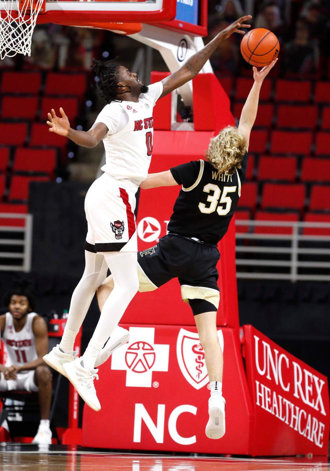N.C. State’s D.J. Funderburk (0) blocks the shot by Wake Forest’s Carter Whitt (35) during the first half of N.C. State’s game against Wake Forest at PNC Arena in Raleigh, N.C., Wednesday, January 27, 2021.