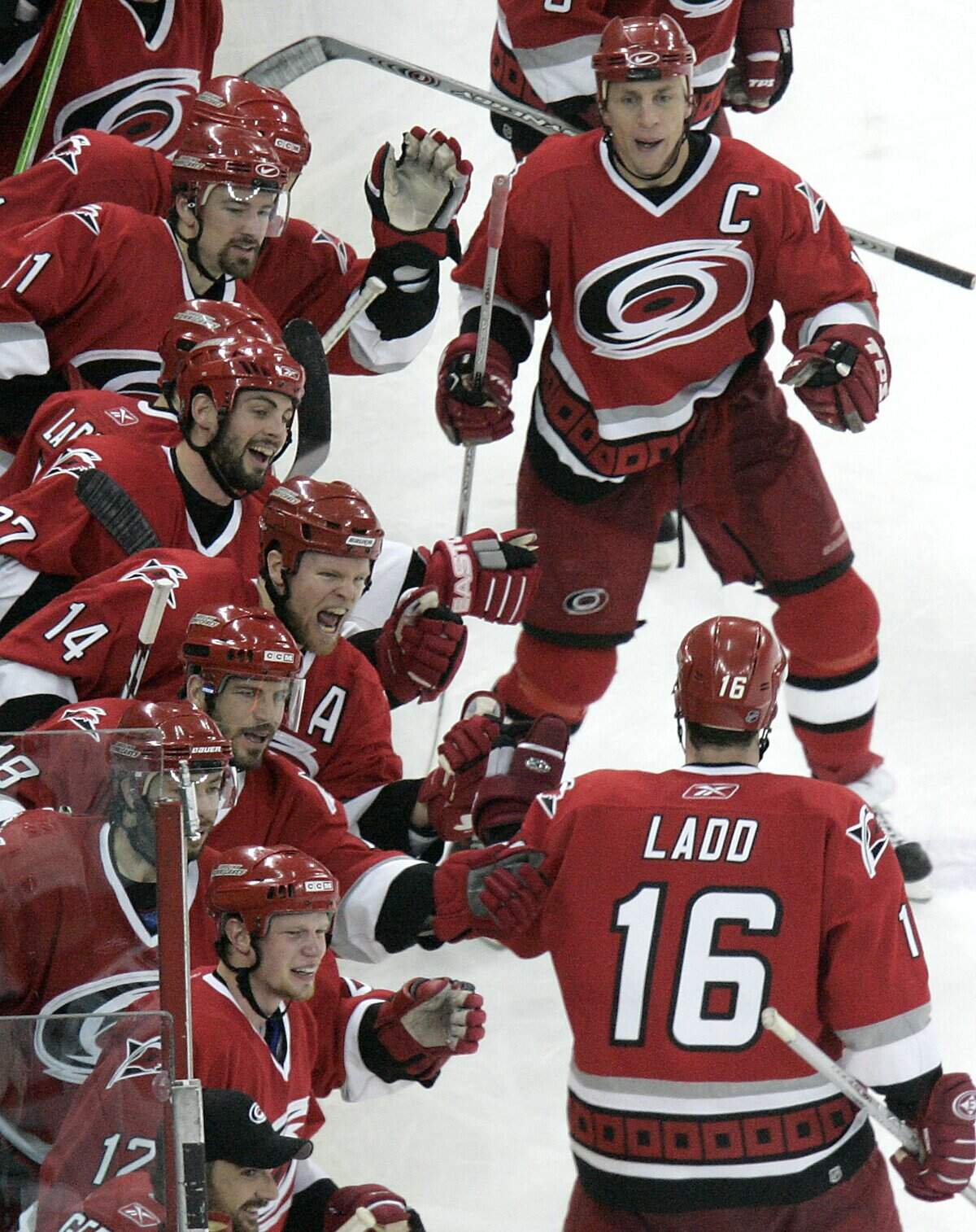 The Carolina Hurricanes bench, and Rod Brind'Amour (top right) greet teammate Andrew Ladd (16) following Ladd's assist to Ray Whitney in the third period which put the Canes up 3-1 over the New Jersey Devils of Game 5 of the NHL Eastern Conference Semifinals on Sunday, May 14, 2006, at the RBC Center.