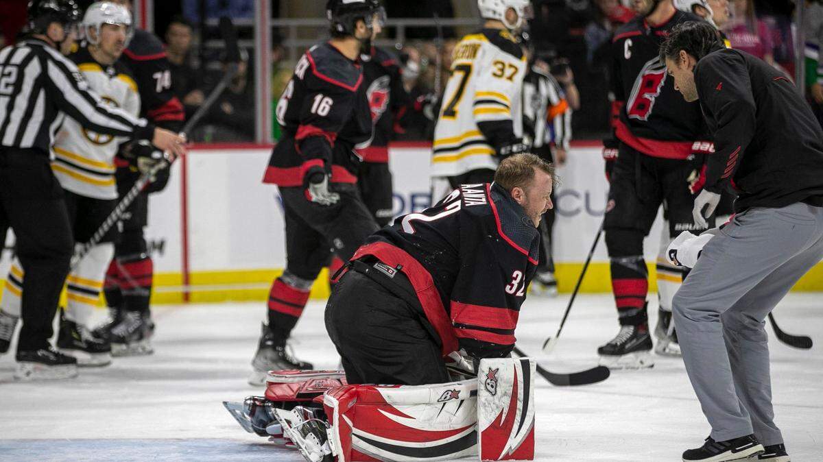 Carolina Hurricanes goalie Antii Raanta (32) rises to his knees after being hit from behind by Boston Bruins David Pastrnak (88) in the first period on Wednesday, May 4, 2022 during game two of their Stanley Cup first round series at PNC Arena in Raleigh, N.C. Antii was injured left the game.