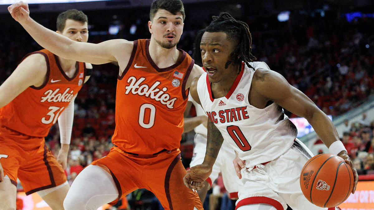 N.C. State’s DJ Horne drives past Virginia Tech’s Hunter Cattoor during the first half of the Wolfpack’s game on Saturday, Jan. 20, 2024, at PNC Arena in Raleigh, N.C.