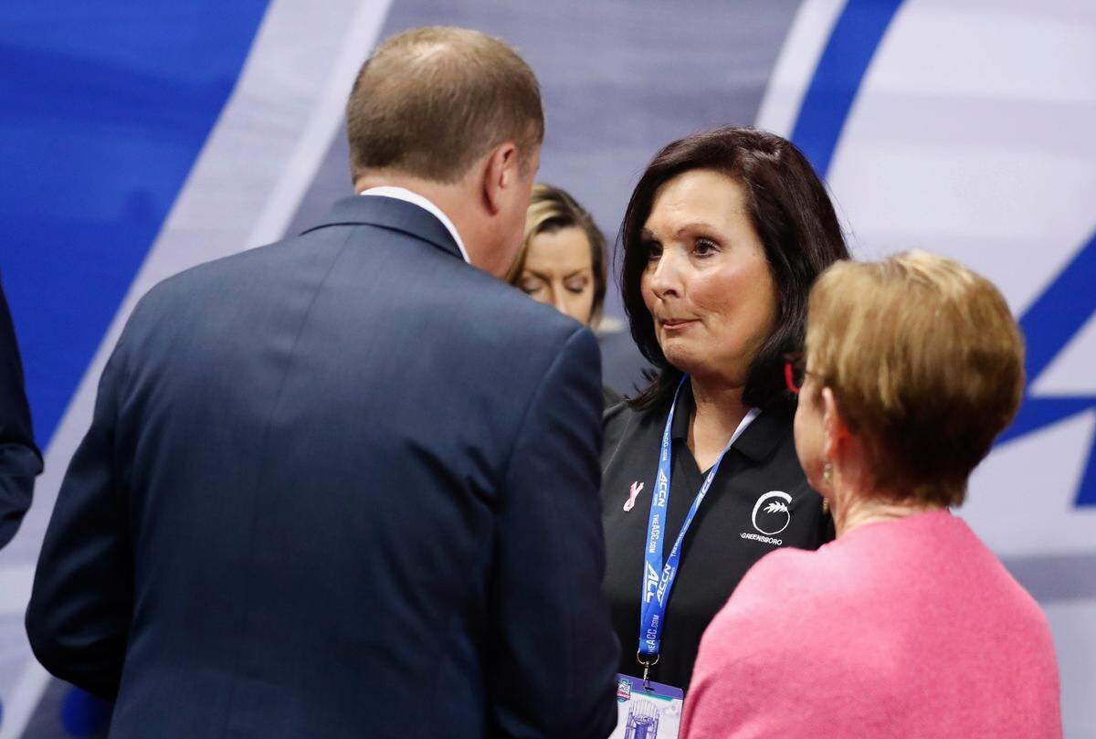Greensboro mayor Nancy Vaughan talks with ACC Commissioner Jim Phillips during N.C. State’s game against Miami in the championship of the ACC women’s basketball tournament in Greensboro, N.C., Sunday, March 6, 2022.