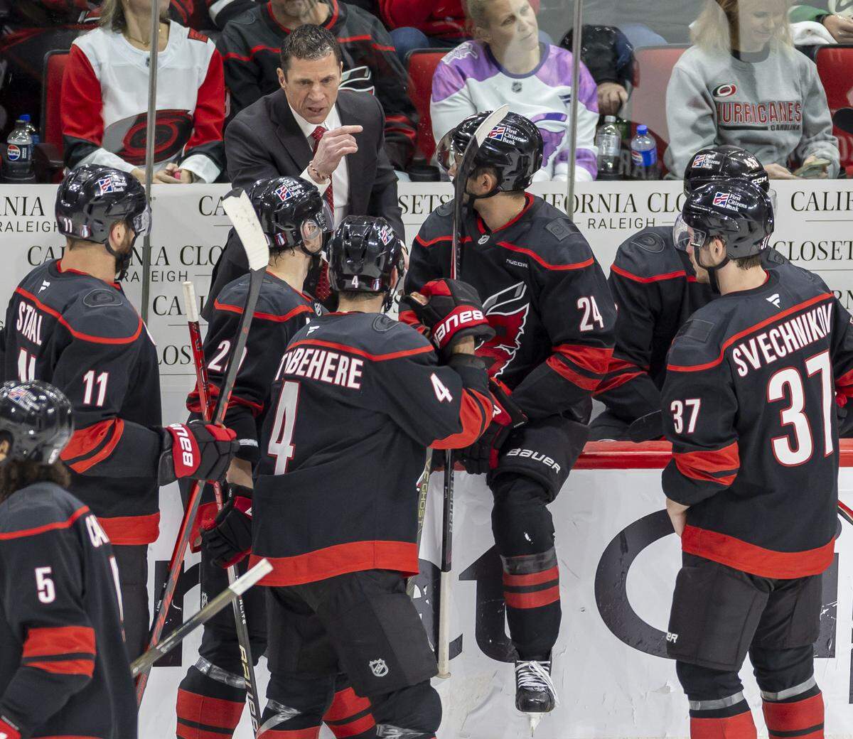 Carolina Hurricanes head coach Rod Brind’Amour huddles with Jordan Staal (11), Sebastian Aho (20), Shayne Gostisbehere (4) and Andrei Svechnikov (37) in the second period against Philadelphia during Game 2 on Monday, May 4, 2026, during the second round of the Stanley Cup Playoffs at Lenovo Center in Raleigh, N.C.