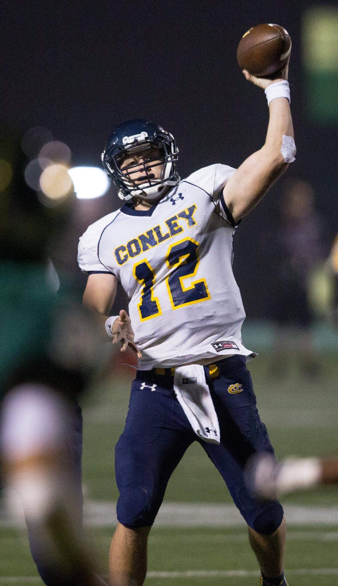 D.H. Conley’s Holton Ahlers (12) throws the ball during a high school football game against Cardinal Gibbons in Raleigh, N.C. on Friday, Nov. 18, 2016.