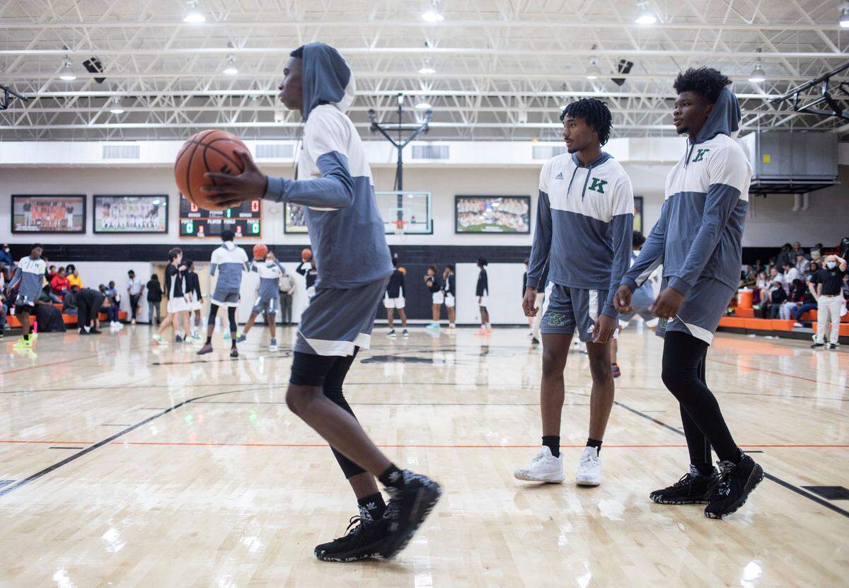 Kinston High School varsity basketball players Jyrah Canady, left, Dominic Clark, middle, and Ricardo Harris, right, warm up before their game at Southwest Onslow High School in Jacksonville, N.C. on Jan. 5, 2022.