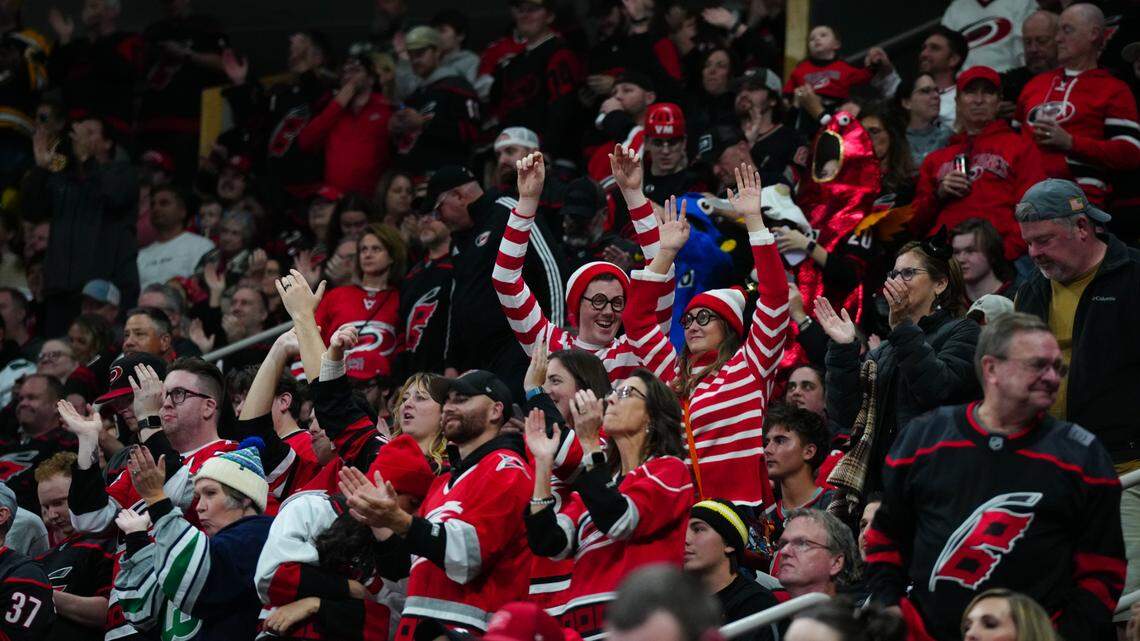 Carolina Hurricanes fans celebrate against the Boston Bruins during the second period at Lenovo Center.