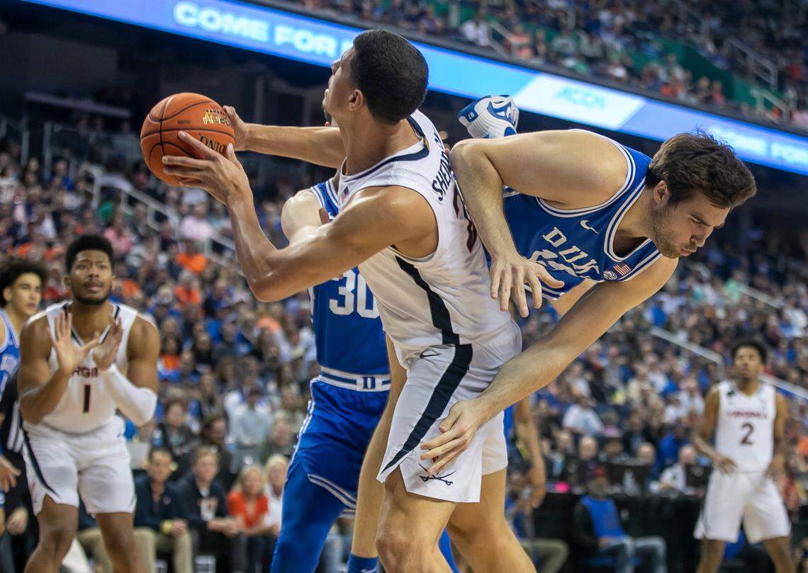 Duke’s Ryan Young (15) collides with Virginia’s Kadin Shedrick (21)during the second half of the championship game of the ACC Tournament on Saturday, March 11, 2023 at the Greensboro Coliseum in Greensboro, N.C.