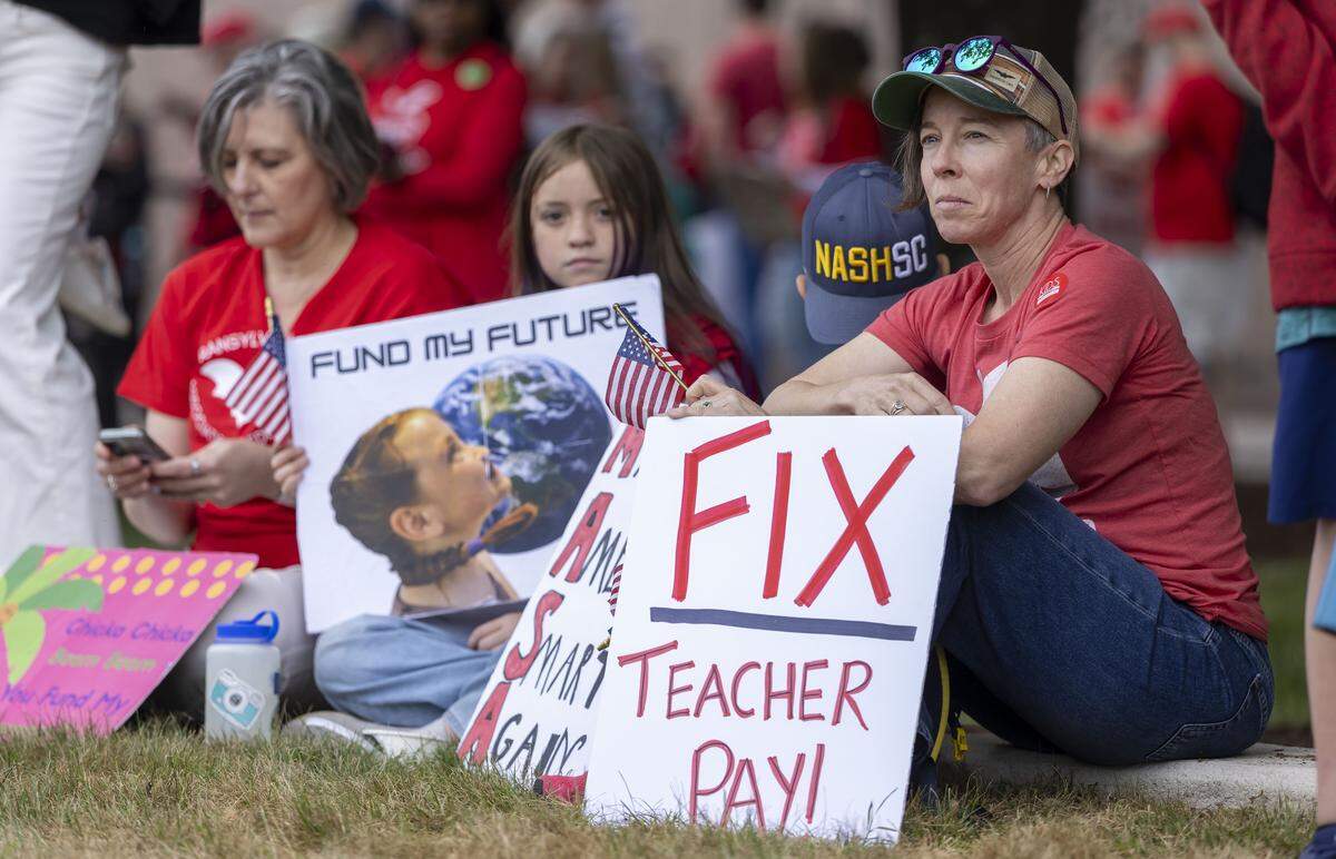 Katie Messmer, a special education teacher from Transylvania County, waits for the start the May Day protest on the Halifax Mall, on Friday, May 1, 2026 in Raleigh, NC.