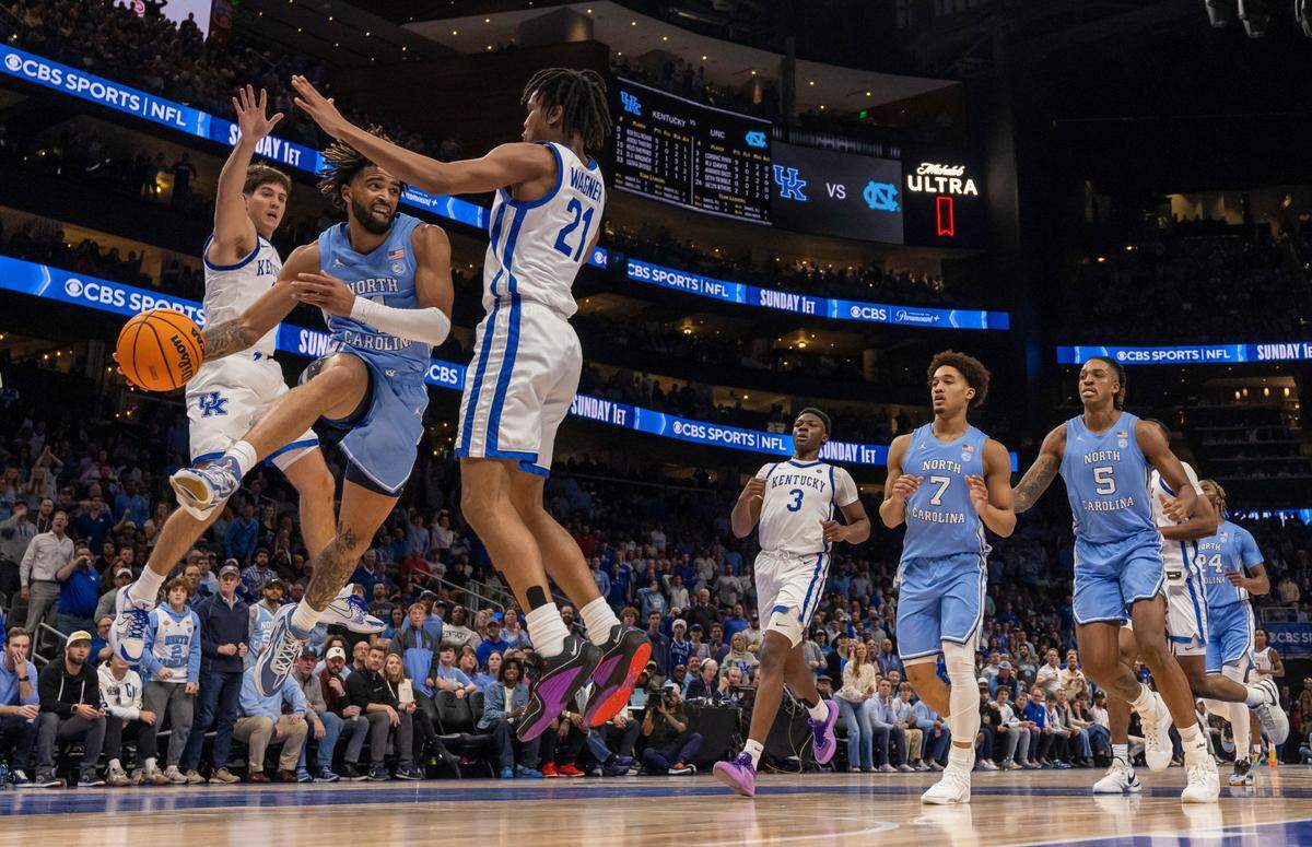 North Carolina’s R.J. Davis (4) drives against Kentucky’s D.J. Wagner (21) in the first half on Saturday, December 16, 2023 at State Farm Arena in Atlanta, Georgia.