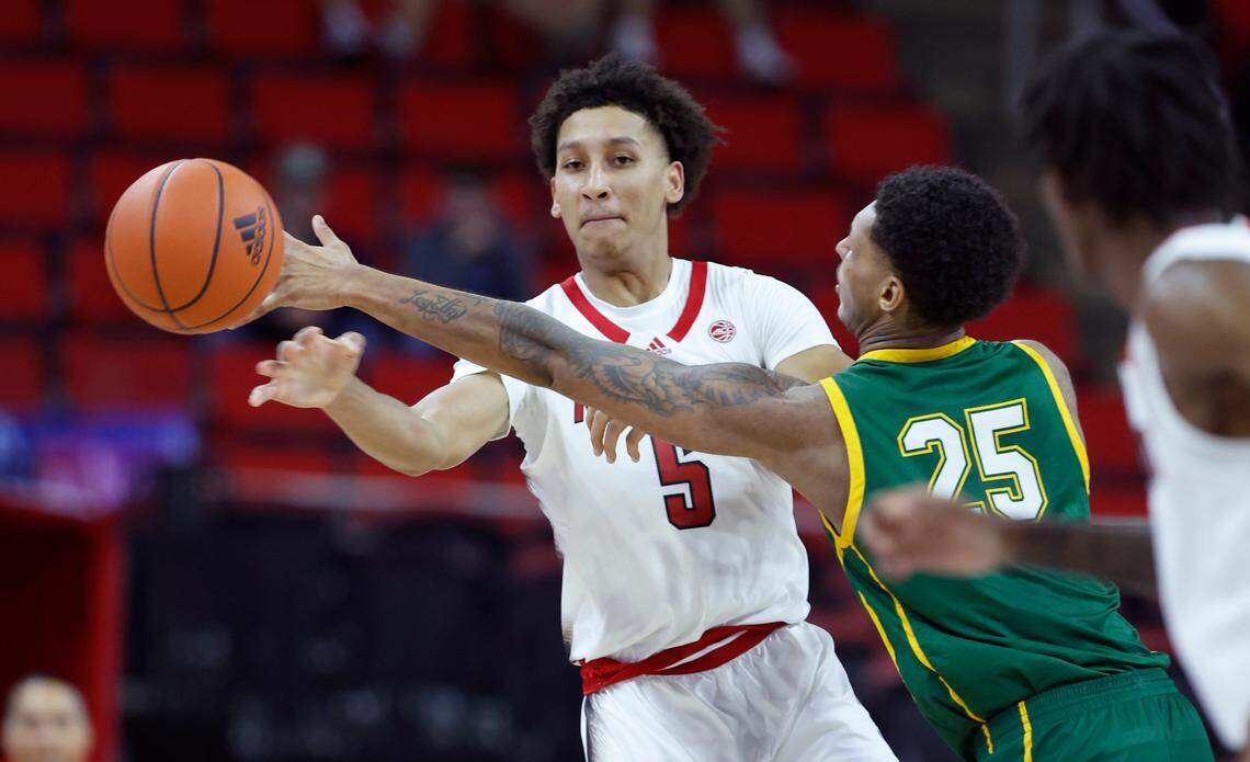 N.C. State’s Jack Clark (5) passes the ball as Lees-McRae’s Drew Gardner (25) during the first half of N.C. State’s exhibition game against Lees-McRae at PNC Arena in Raleigh, N.C. Wednesday, Nov. 2, 2022.