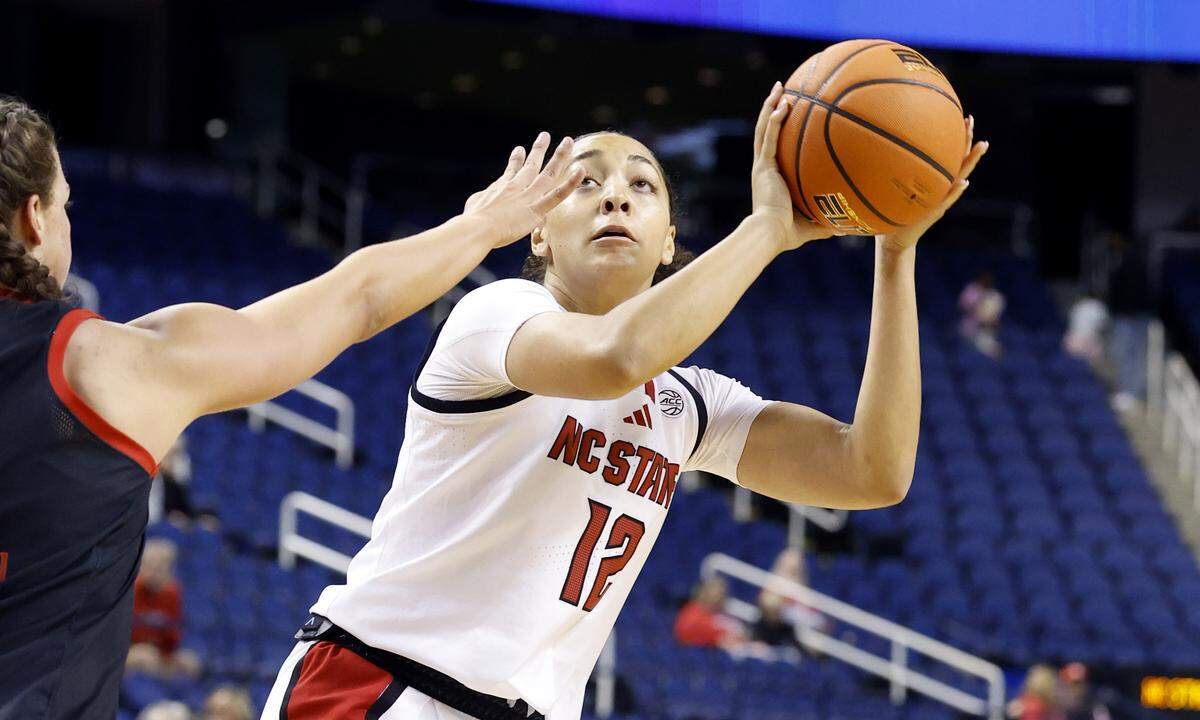 N.C. State's Khamil Pierre (12) prepares to shoot as Maryland's Rainey Welson (0) defends during the first half of N.C. StateÕs exhibition game against Maryland at the First Horizon Coliseum in Greensboro, N.C., Sunday Oct. 26, 2025.