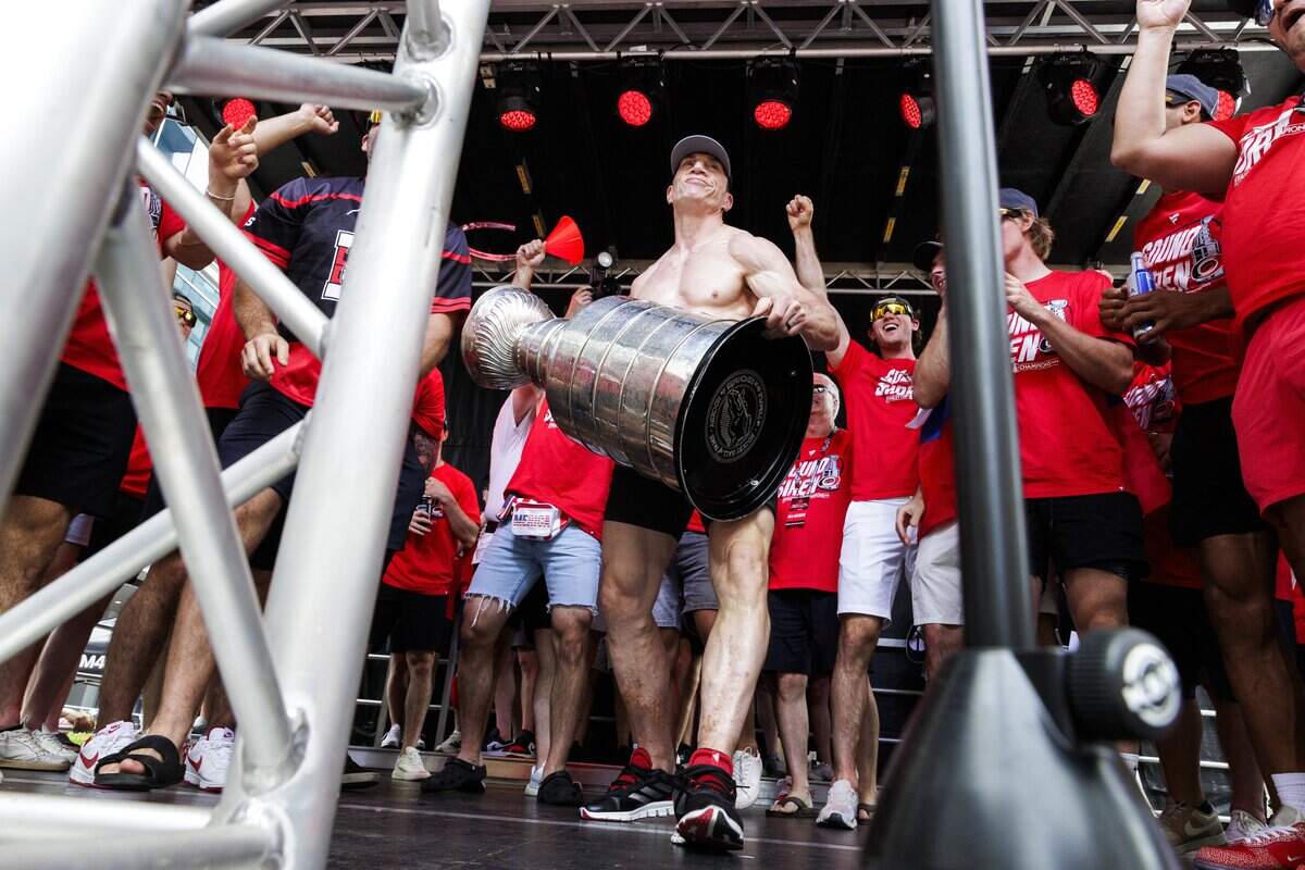 Rod Brind'Amour, head coach of the Carolina Hurricanes, struts toward the podium as he prepares to lift the Stanley Cup during a rally on Saturday, June 20, 2026, in downtown Raleigh.