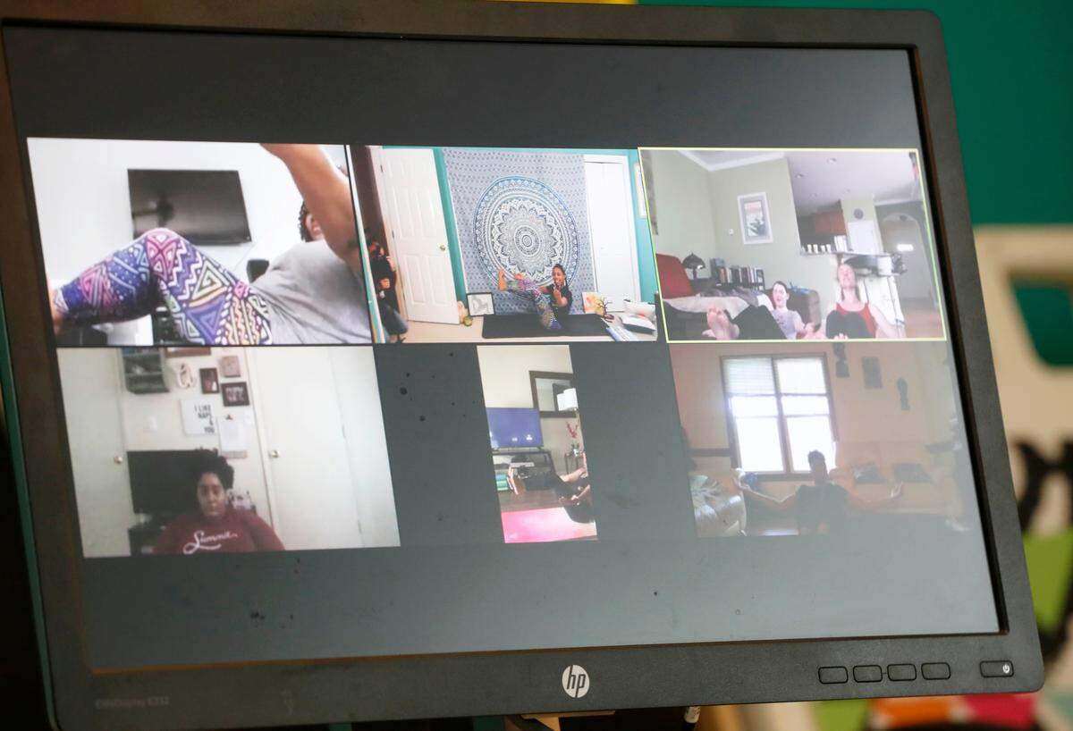 Patrice Graham, owner of Colors of Yoga Raleigh, leads a virtual yoga class using Zoom in her home Wednesday, March 25, 2020. Zoom allows Graham to interact and connect with her students.