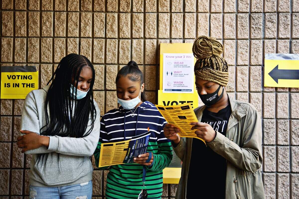 Saint Augustine’s University students prepare to vote Tuesday, Nov. 3, 2020, after marching to the polls at Tarboro Road Community Center in Raleigh.