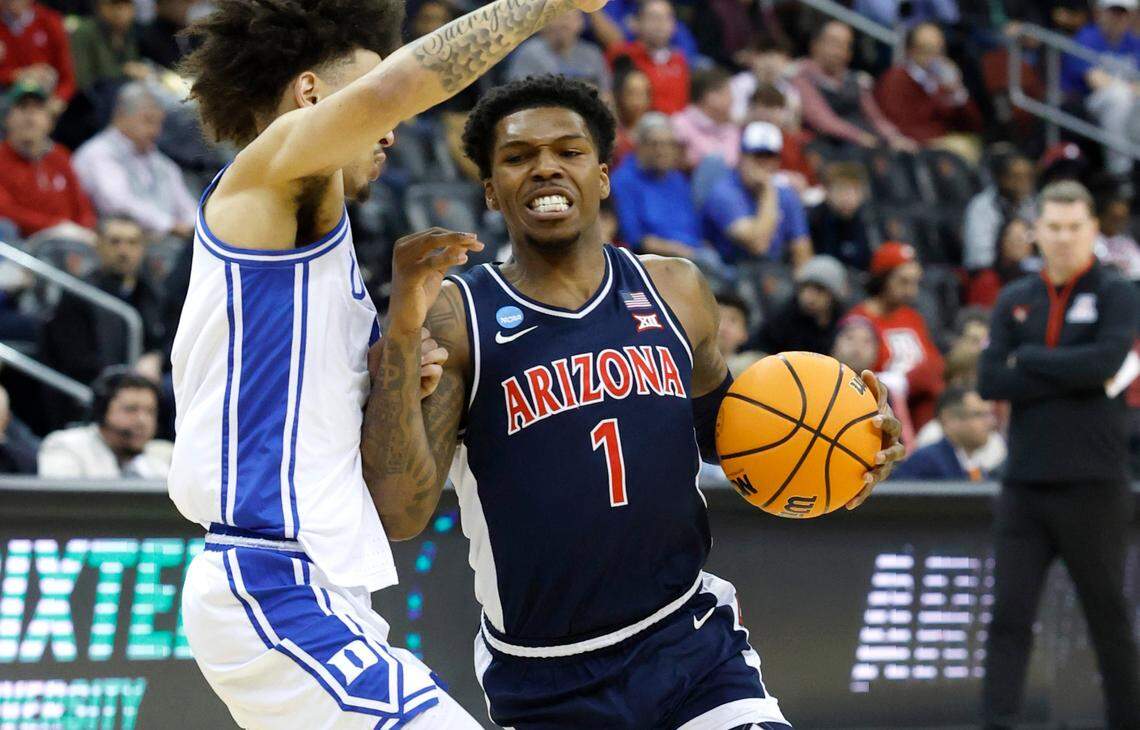 Arizona’s Caleb Love (1) drives by Duke’s Tyrese Proctor (5) during the first half of Duke’s game against Arizona in the Sweet 16 round of the 2025 Men’s NCAA Basketball Championship at the Prudential Center in Newark, N.J., Thursday, March 27, 2025.