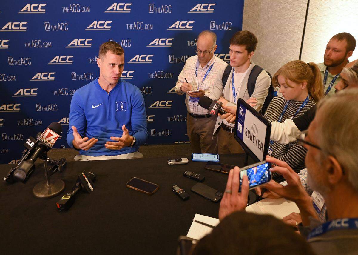 Duke head coach Jon Scheyer, left, responds to a reporter’s question during the ACC Men’s TipOff event at the Hilton Charlotte Uptown Hotel on Wednesday, October 25, 2023 in Charlotte, NC.