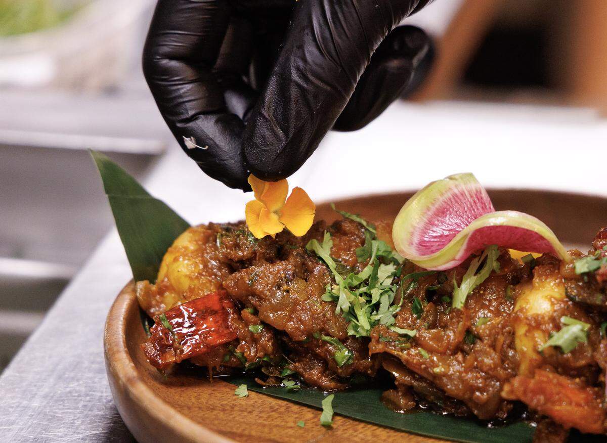 Executive Chef Vinod Kumar prepares Imli Shrimp at Barsa on Thursday, Sept. 25, 2025, in Durham, N.C. Barsa is one of a few dozen Triangle restaurants open on Christmas Day.