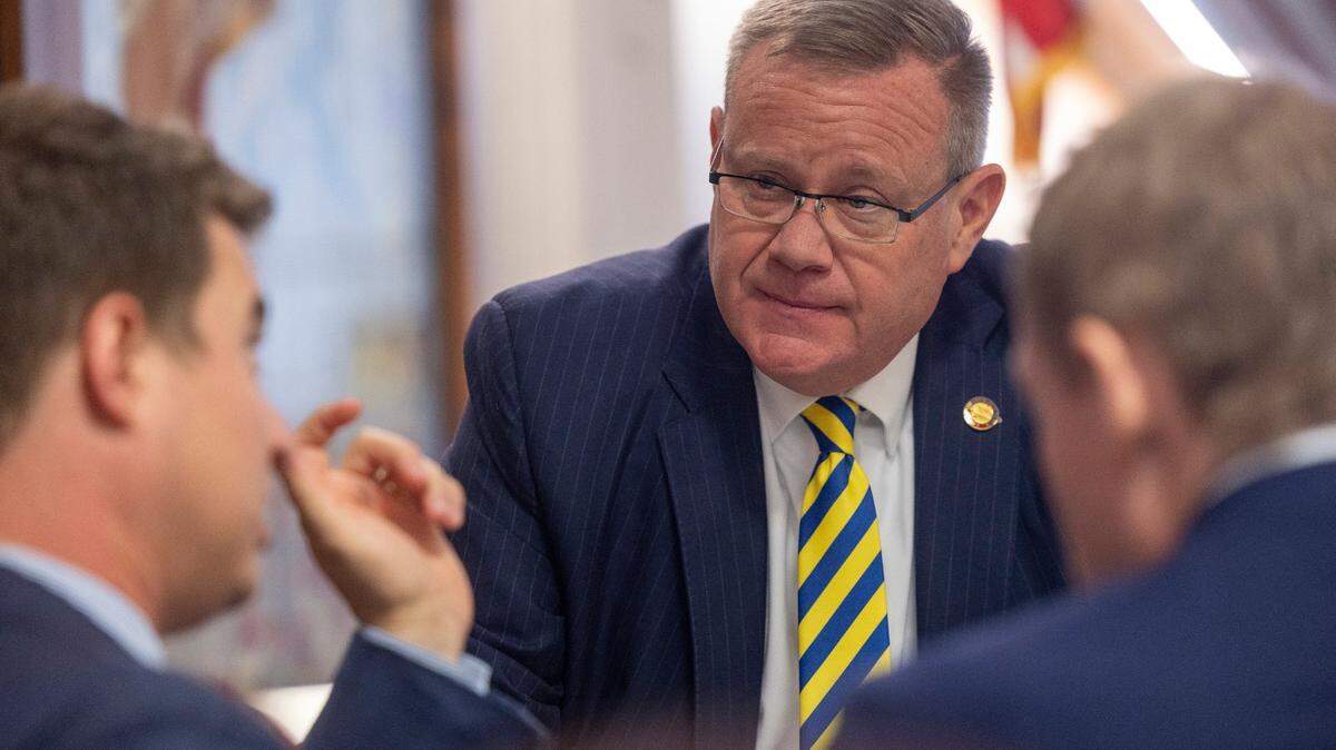 House Speaker Tim Moore, center, confers with his chief of staff, Neal Inman, left, and Rep. Destin Hall, in this Sept. 21, 2023 file photo, prior to budget votes.