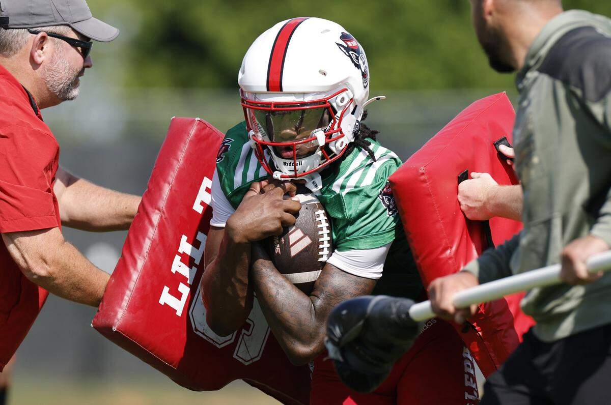 N.C. State quarterback CJ Bailey (11) runs drills during the Wolfpack’s first fall practice Wednesday, July 30, 2025.