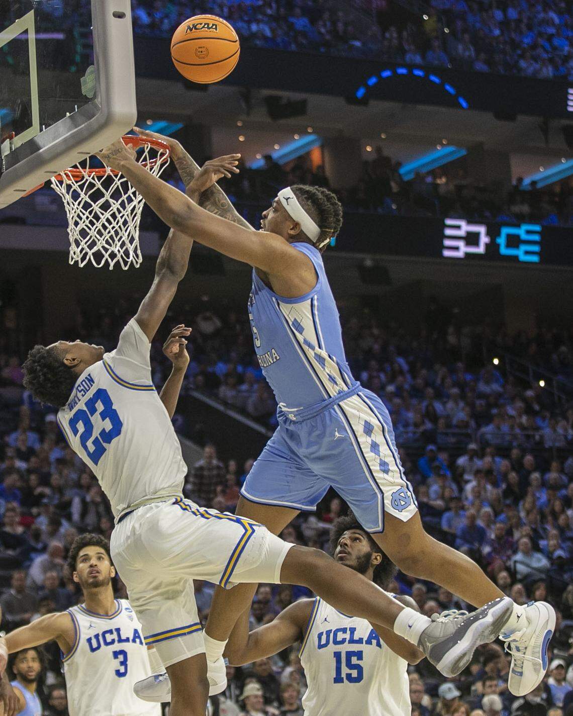 UCLA’s Peyton Watson (23) blocks a shot by North Carolina’s Armando Bacot (5) in the first half on Friday, March 25, 2022 during the NCAA East Regional semi-final at Wells Fargo Center in Philadelphia, Pa.
