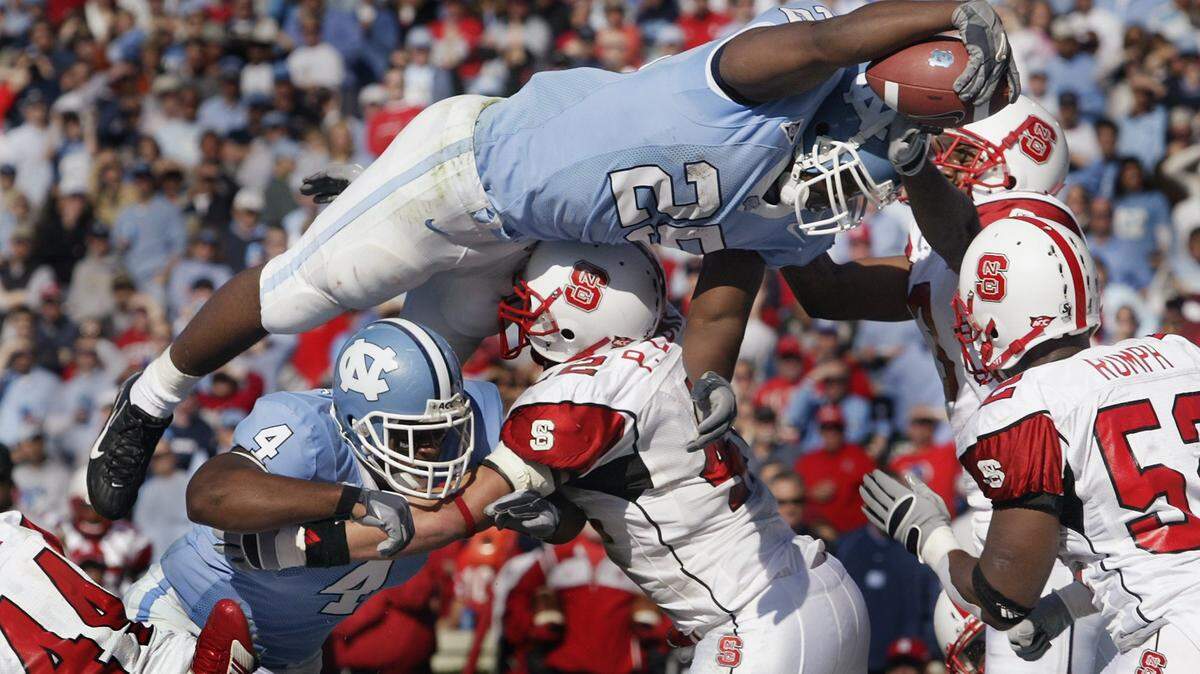 UNC’s Ronnie McGill (25) goes over the top for a touchdown in the first half of their game at Kenan Stadium on Saturday, Nov. 18, 2006.