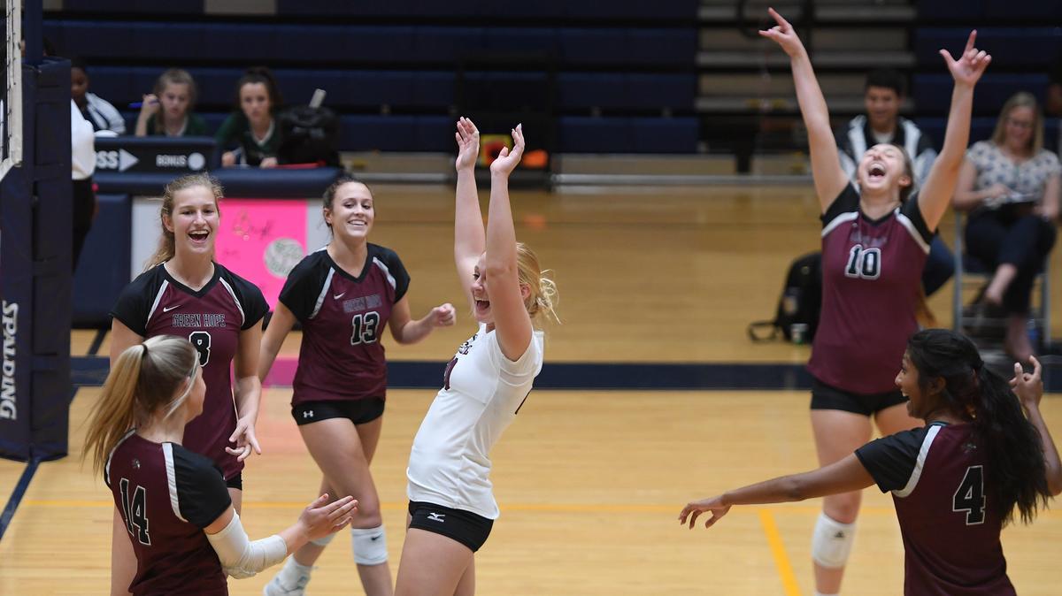 Green Hope players celebrate a point against the Hillside Hornets in a high school volleyball game on October 16, 2019. Green Hope is seeking a fourth consecutive NCHSAA championship.