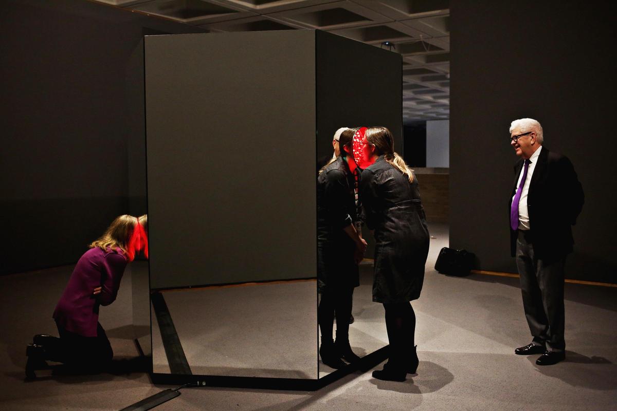 From left, Linda Dougherty, NCMA chief curator, Kat Harding NCMA public relations manager, and NCMA’s former director Larry Wheeler look over the North Carolina Museum of Art’s acquisition, Yayoi Kusama’s “Light of Life” on Monday, March 26, 2018. From the outside, the piece looks like a mirrored hexagonal box but stick your head inside one of its three portholes, and you’ll see yourself transported into an enclosed “infinity room” of changing colors and patterns.