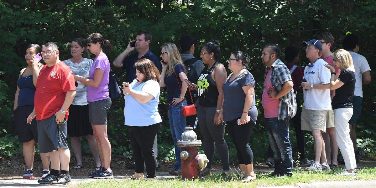 Anxious parents stand on the corner of Dixon Road waiting for Sanderson High School students to be released after the Wake County school system posted the following on Twitter at about 2:05 p.m. Monday: "Sanderson High School is in Code Red while the school investigates information they received. In Code Red, students moved into safe areas and all interior doors locked. No one is allowed on campus. More information will be provided when it is available."  The students were released after about 35 minutes in Raleigh, N.C., Monday, May 14, 2018.
