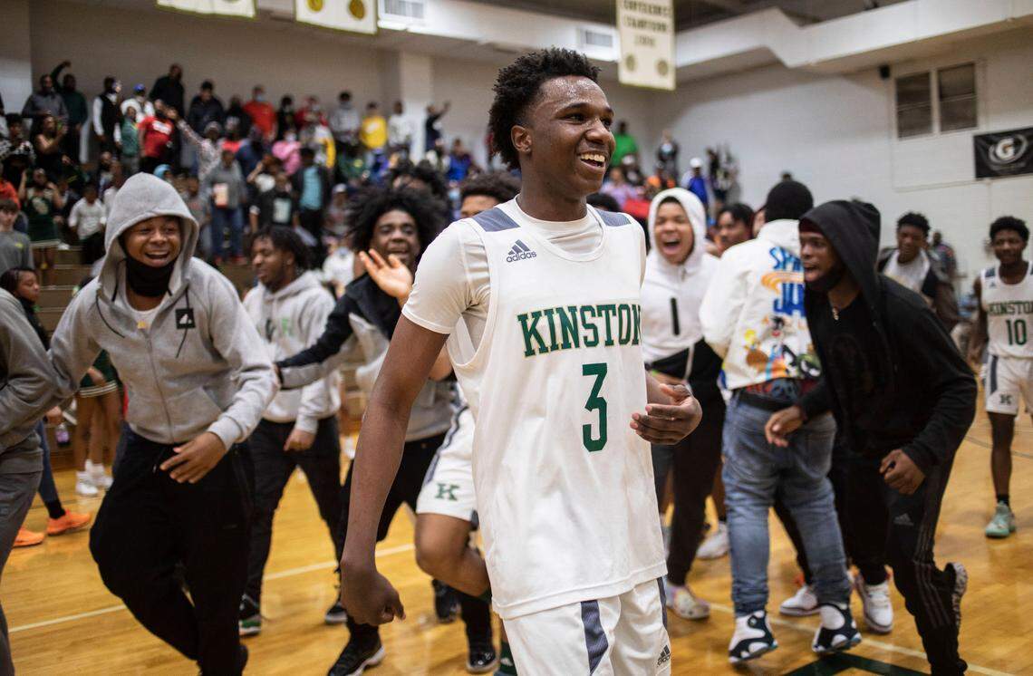 Kinston Vikings junior Jaylen Cobb (3) smiles while surrounded by cheering fans after the Vikings won their fourth payoff game against the undefeated Cummings High Cavaliers in Kinston, N.C. on Tuesday, March 1, 2022.