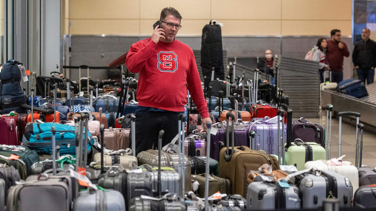 Troy March of Raleigh tries to find lost luggage Thursday morning, December 2022 at RDU International Airport after a Wednesday night flight from Dallas.