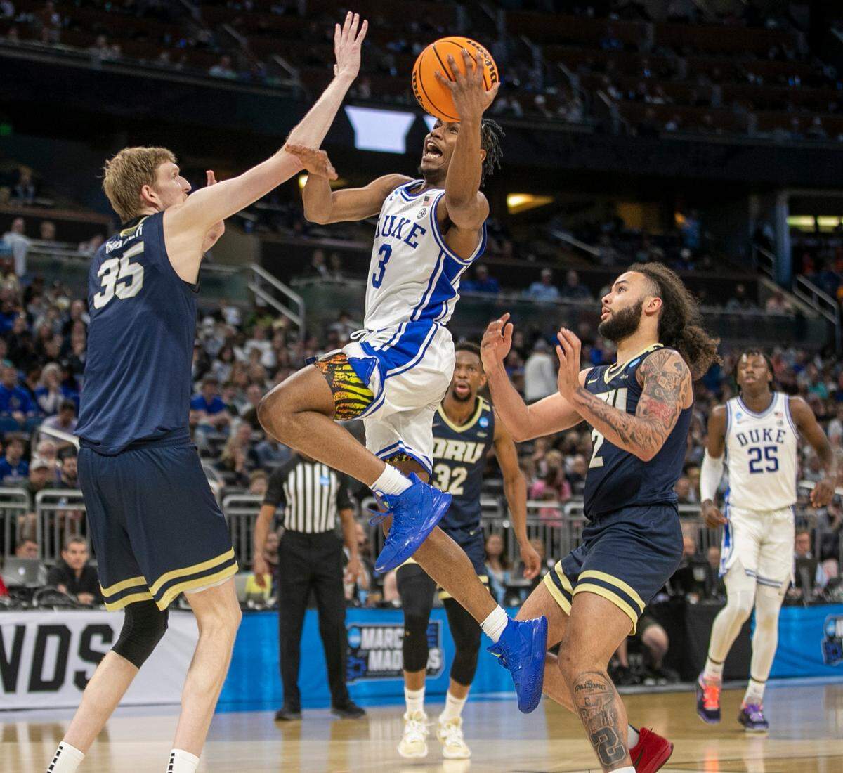Duke’s Jeremy Roach (3) drives to the basket between Oral Roberts’ Connor Vanover (35) and Kareem Thompson (2) in the second half during the first round of the NCAA Tournament on Thursday, March 16, 2023 at the Amway Center in Orlando, Fla.