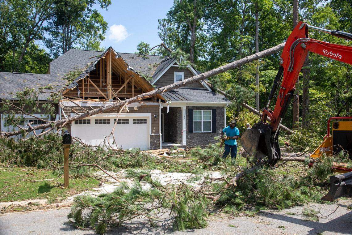 Workers clear debris from a tornado damaged home in the Belmont Lake Golf Club community in Rocky Mount Thursday, July 20, 2023. An EF3, tornado with wind speeds of 150 mph touched down in Nash County Wednesday around 12:30 p.m. Wednesday according to the Raleigh National Weather Service.